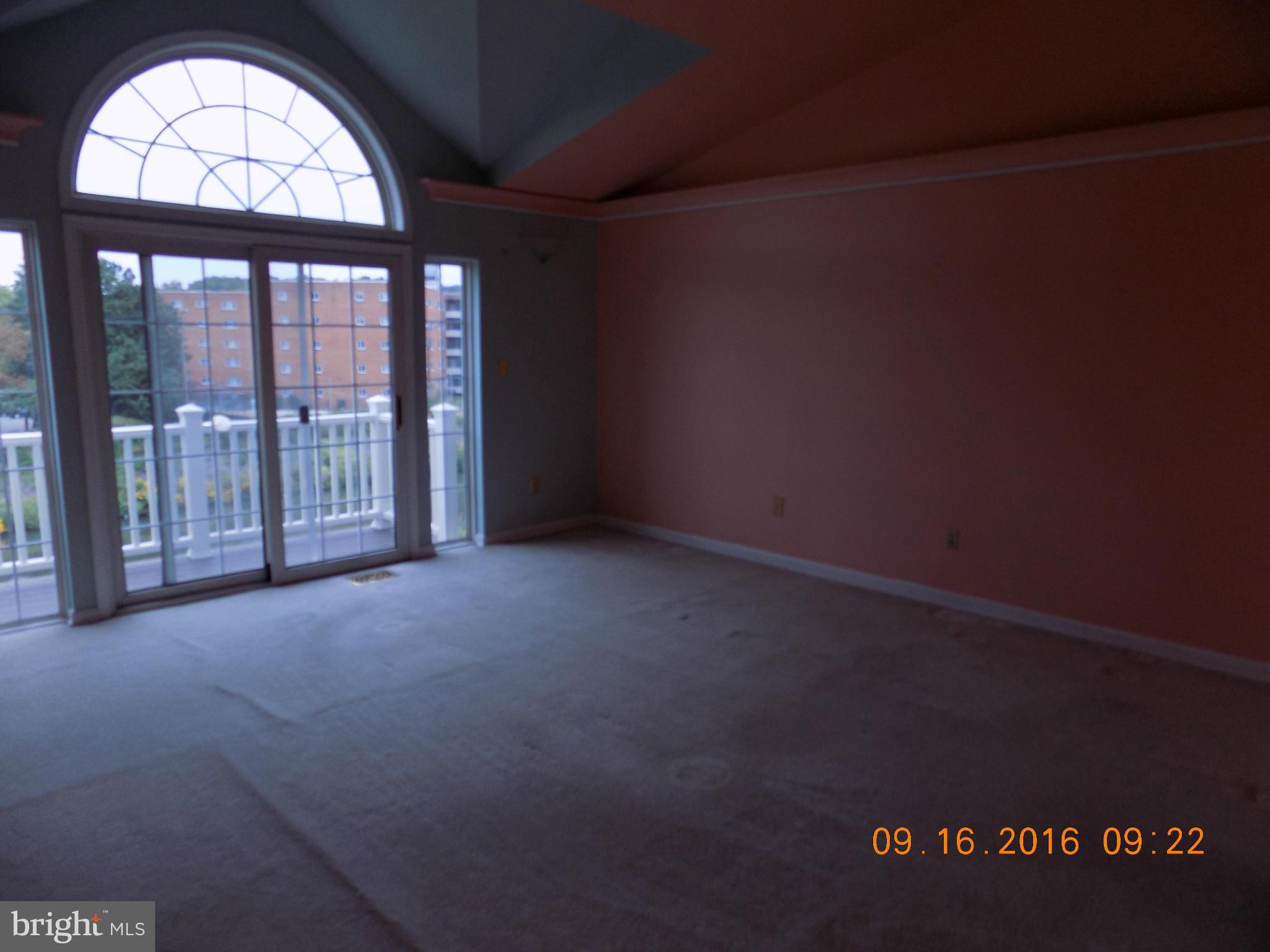 3038 South Glebe Road Arlington, VA 22206 - Photo 16 of 26 an empty room with wooden floor and a fireplace