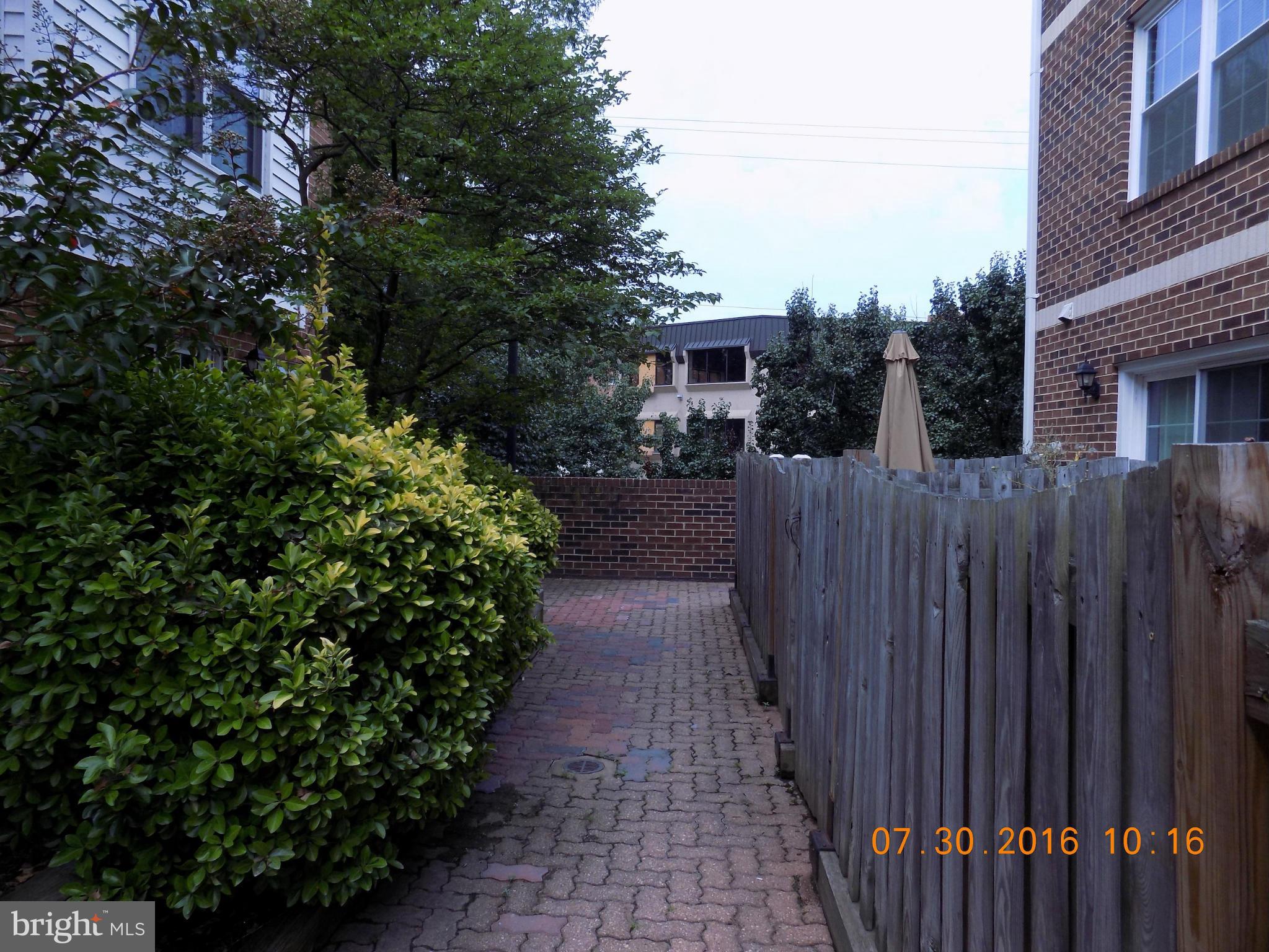 3038 South Glebe Road Arlington, VA 22206 - Photo 21 of 26 a view of a pathway of a house with wooden fence