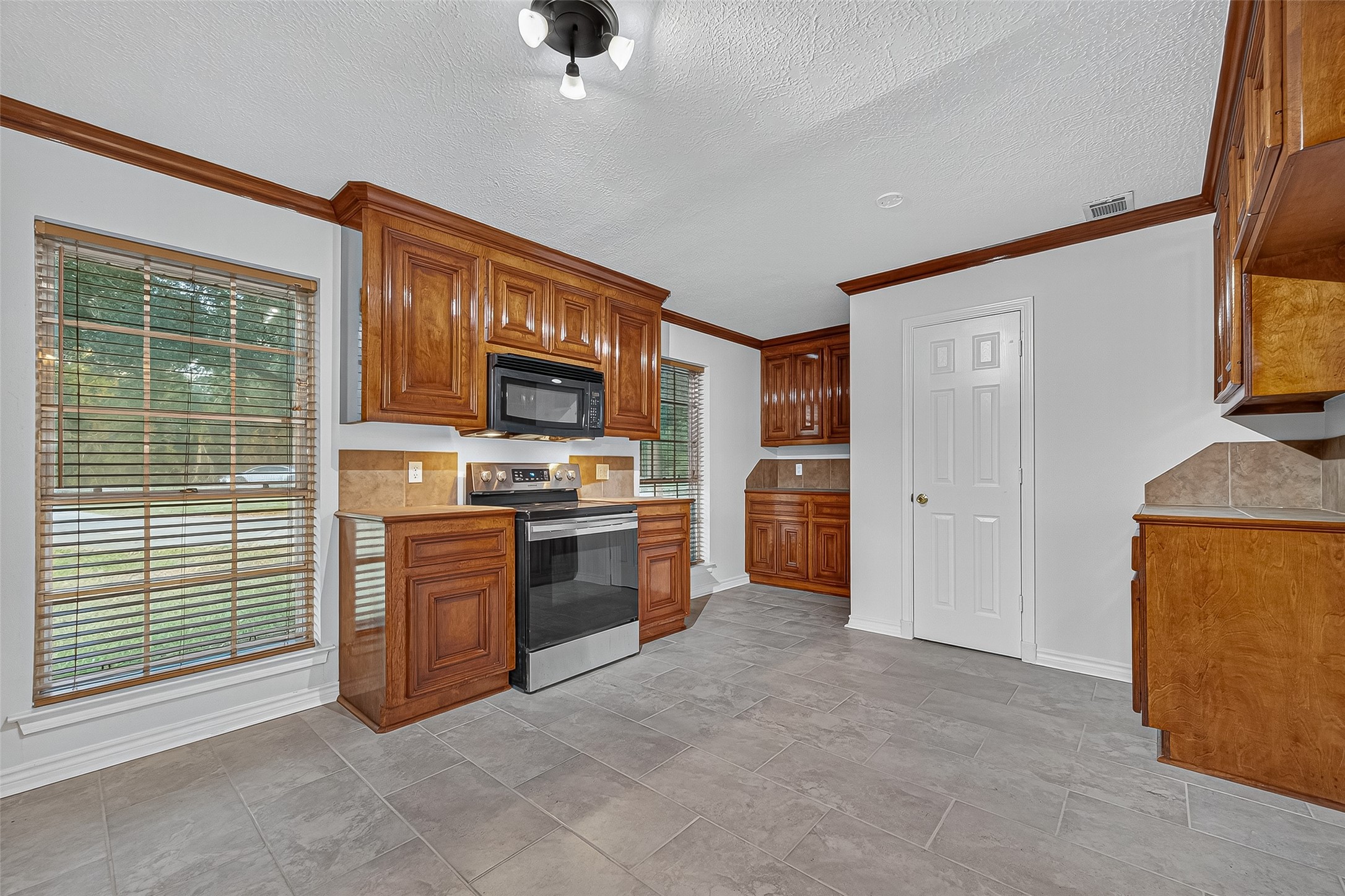 3122 Kueck Road Rosenberg, TX 77471 - Photo 5 of 25 a view of kitchen with stainless steel appliances granite countertop a stove top oven