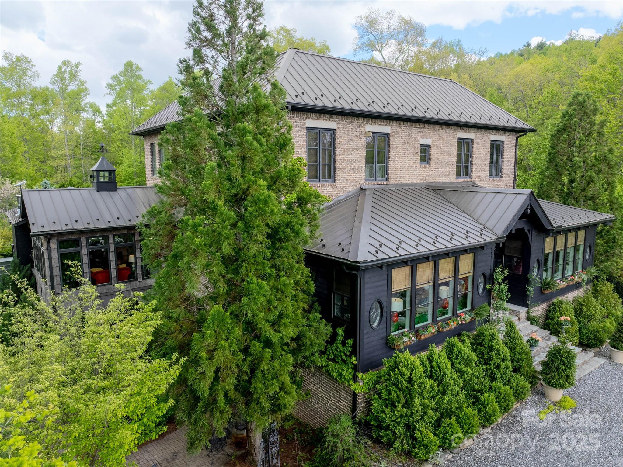 13084 Canada Road Tuckasegee, NC 28783 - Photo 2 of 48 a aerial view of a house with a yard and potted plants