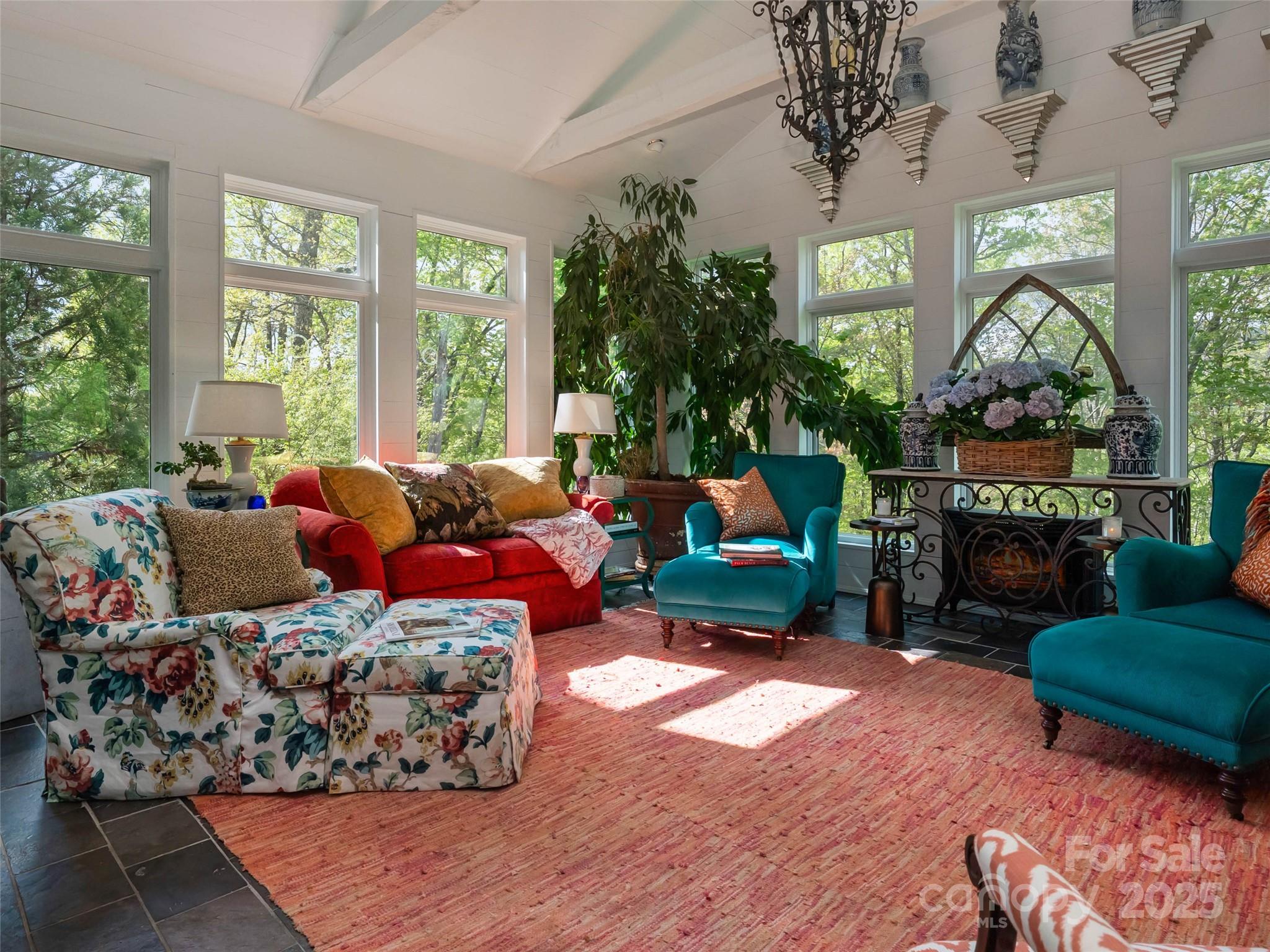 13084 Canada Road Tuckasegee, NC 28783 - Photo 34 of 48 a living room with furniture a fireplace and a potted plants