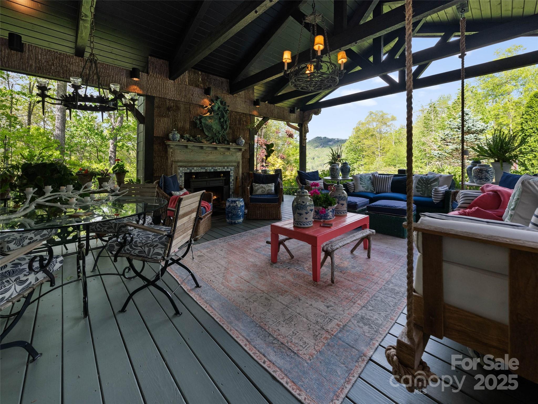 13084 Canada Road Tuckasegee, NC 28783 - Photo 35 of 48 a living room with patio furniture and a fireplace