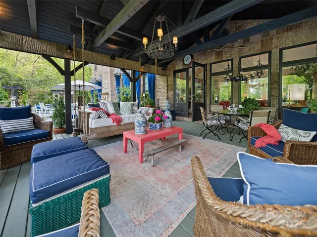 a view of a patio with table and chairs under an umbrella