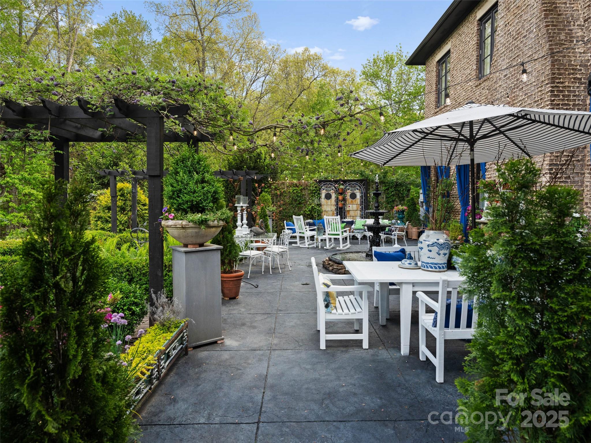 13084 Canada Road Tuckasegee, NC 28783 - Photo 38 of 48 a view of a patio with table and chairs under an umbrella