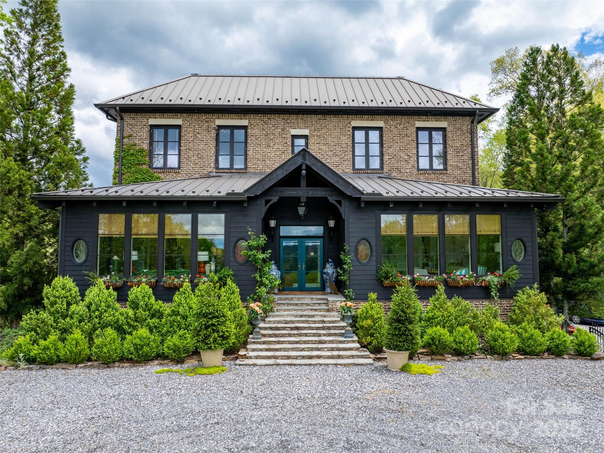 13084 Canada Road Tuckasegee, NC 28783 - Photo 43 of 48 a front view of a house with a yard