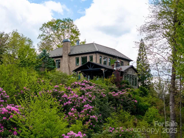 a view of a house with a flower garden