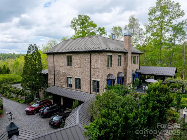a front view of a house with balcony and trees