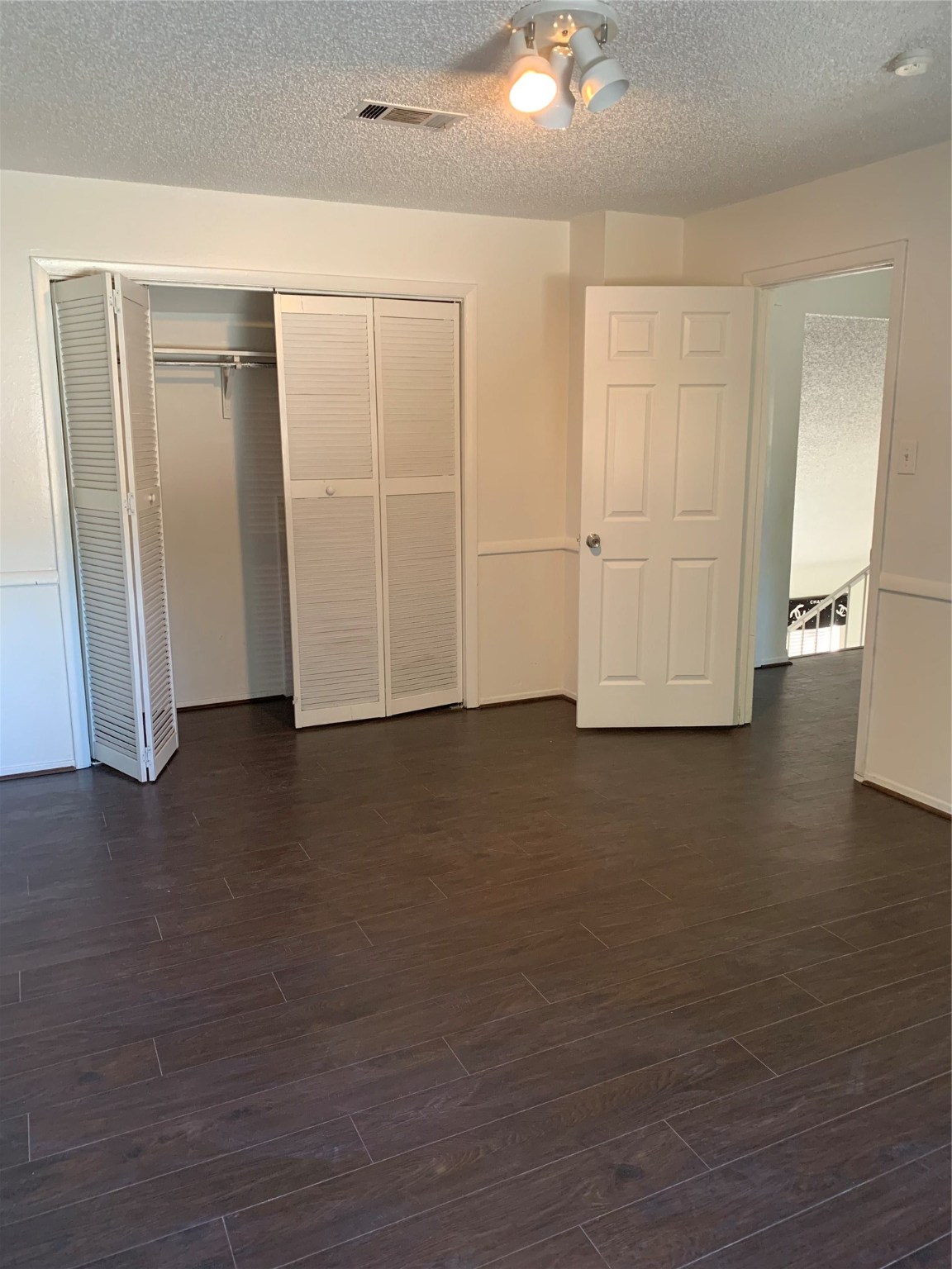11110 Bammel North Houston Road, Unit C Houston, TX 77066 - Photo 12 of 13 Secondary bedroom #3 additional view upstairs. Wood flooring throughout home!