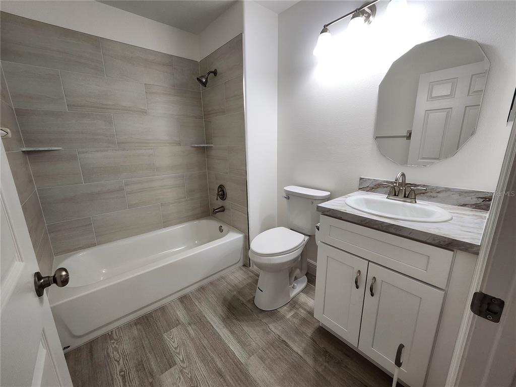4694 Prairie Point Boulevard Kissimmee, FL 34746 - Photo 16 of 23 a bathroom with a sink a toilet and shower