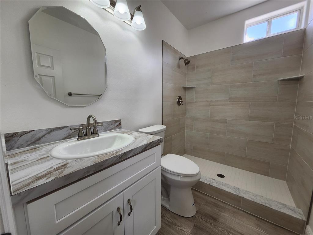 4694 Prairie Point Boulevard Kissimmee, FL 34746 - Photo 19 of 23 a bathroom with a sink and a mirror