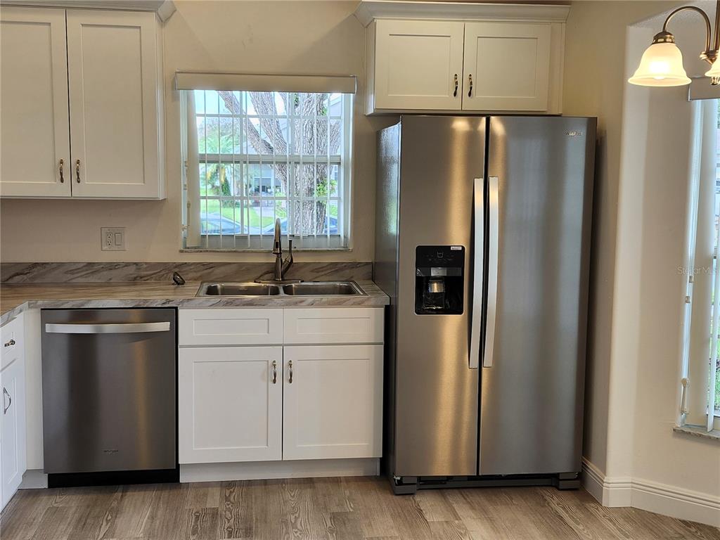 4694 Prairie Point Boulevard Kissimmee, FL 34746 - Photo 4 of 23 a kitchen with stainless steel appliances granite countertop a refrigerator sink and cabinets