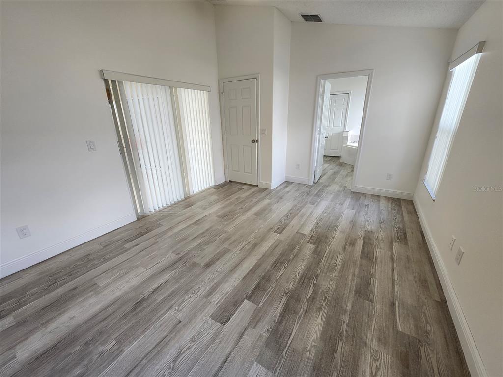4694 Prairie Point Boulevard Kissimmee, FL 34746 - Photo 7 of 23 a view of a room with wooden floor and entryway