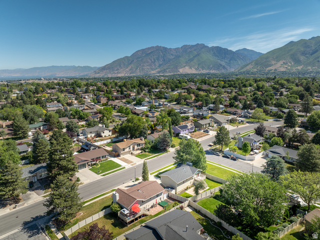 2088 Falcon Way Sandy, UT 84093 - Photo 42 of 46 Expansive residential neighborhood featuring numerous single-family homes, mature trees, and paved streets, all set against a prominent mountain range backdrop