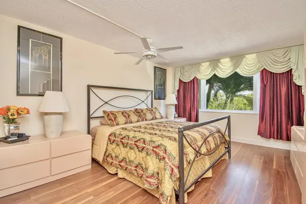 a bedroom with a bed and large window