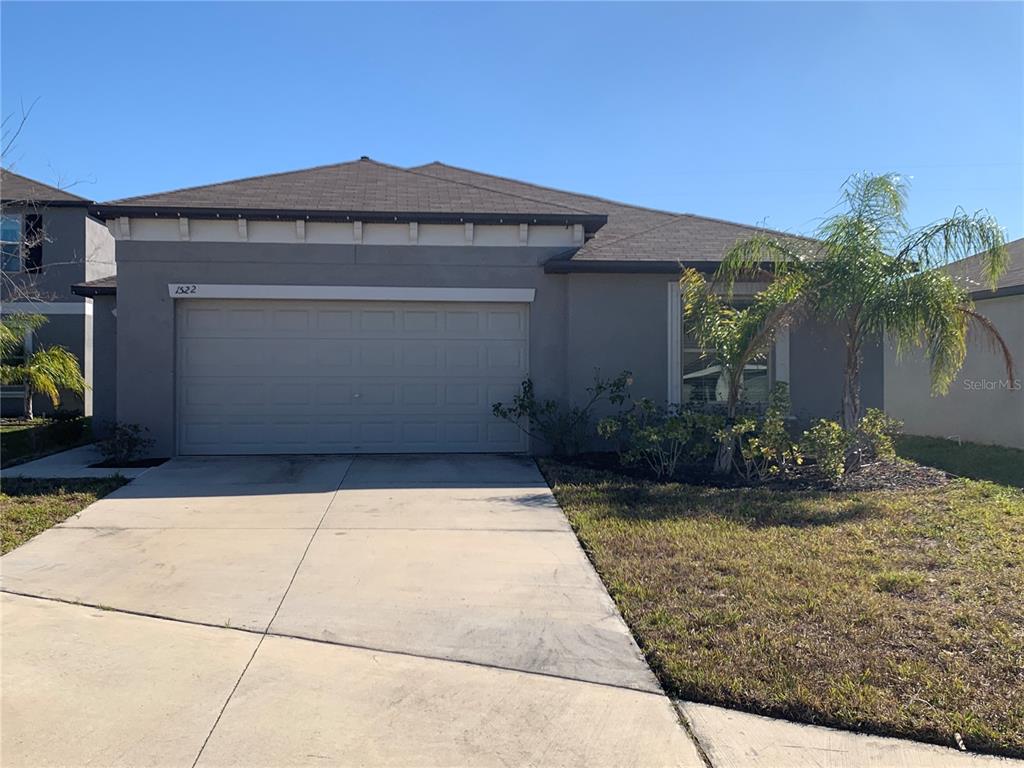 1522 Tiger Tooth Place Ruskin, FL 33570 - Photo 1 of 9 a front view of house with yard