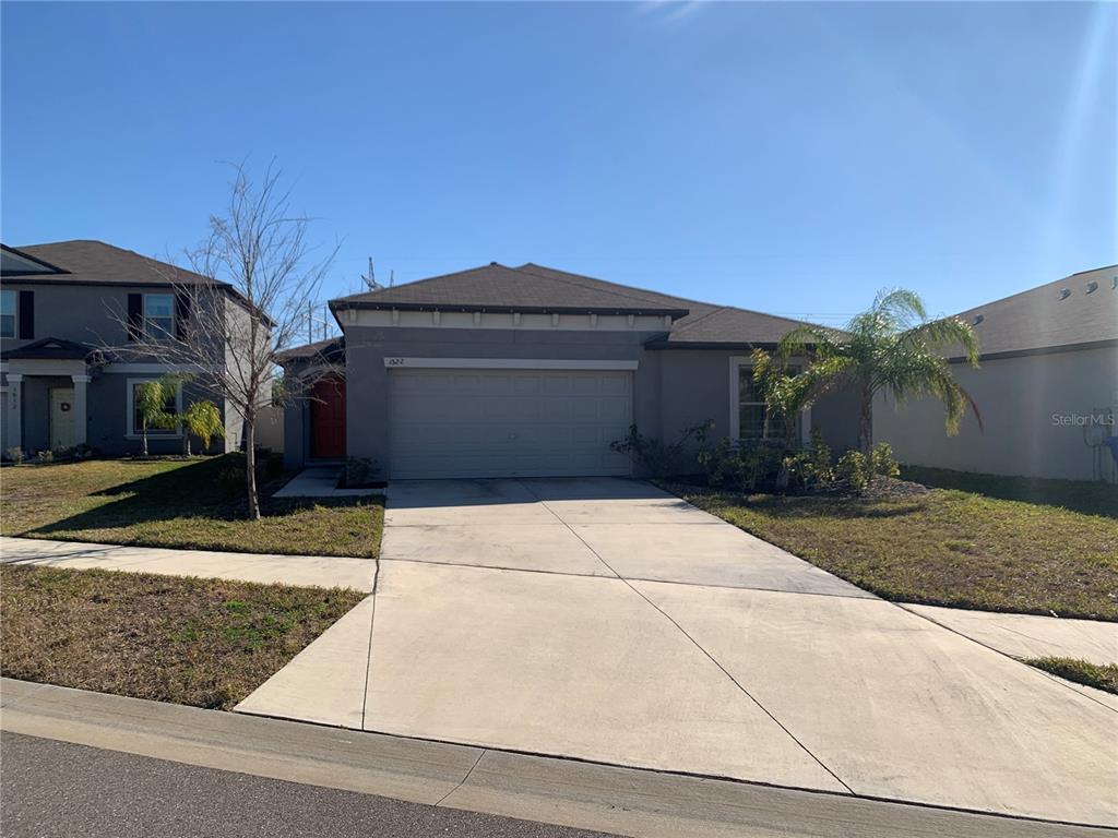 1522 Tiger Tooth Place Ruskin, FL 33570 - Photo 2 of 9 a front view of house with a garden
