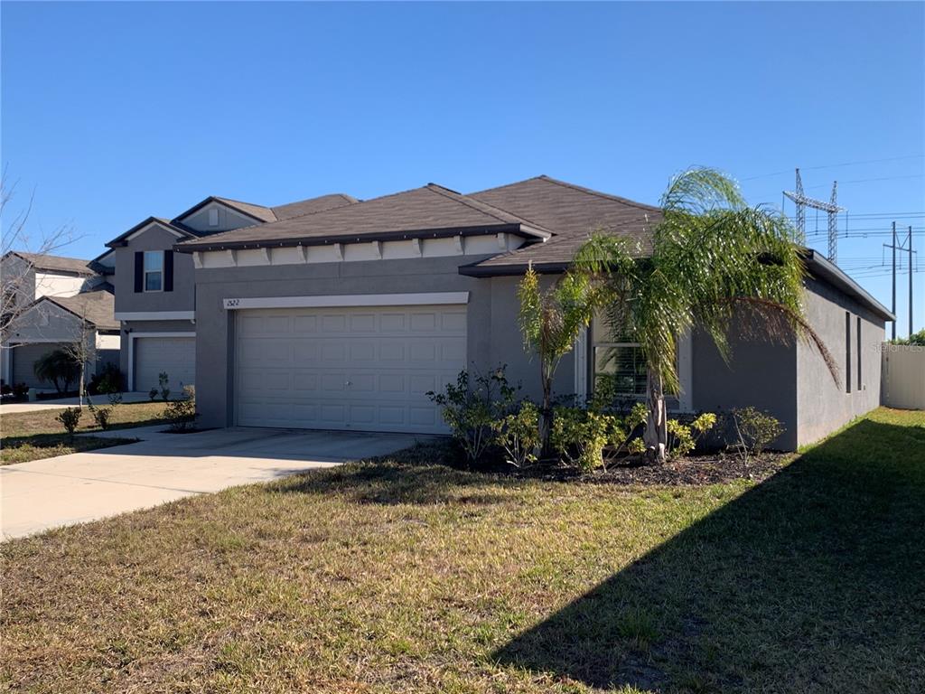 1522 Tiger Tooth Place Ruskin, FL 33570 - Photo 4 of 9 a front view of a house with a yard