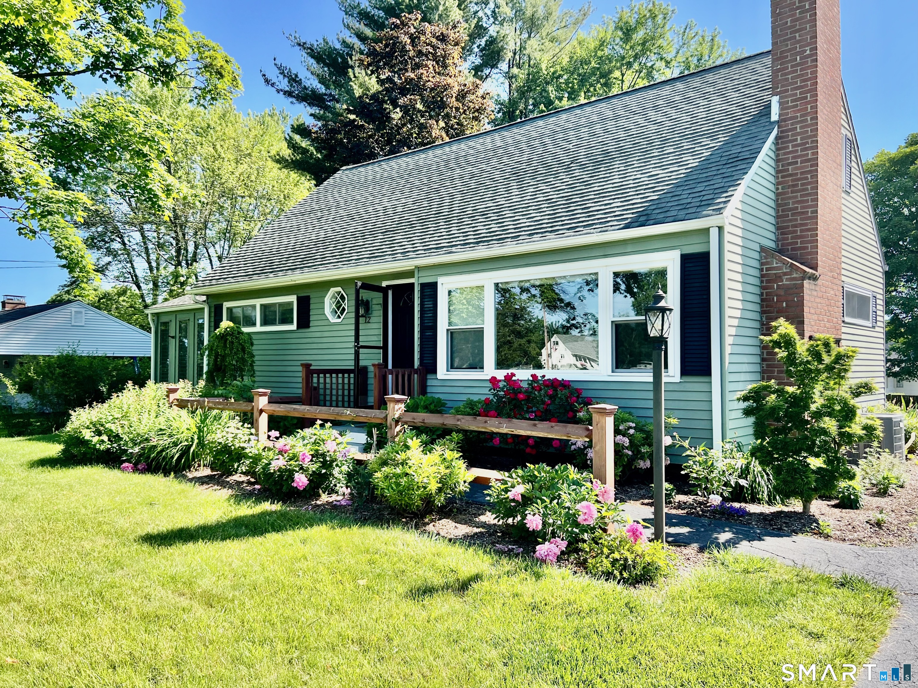 a view of a house with sitting area and garden