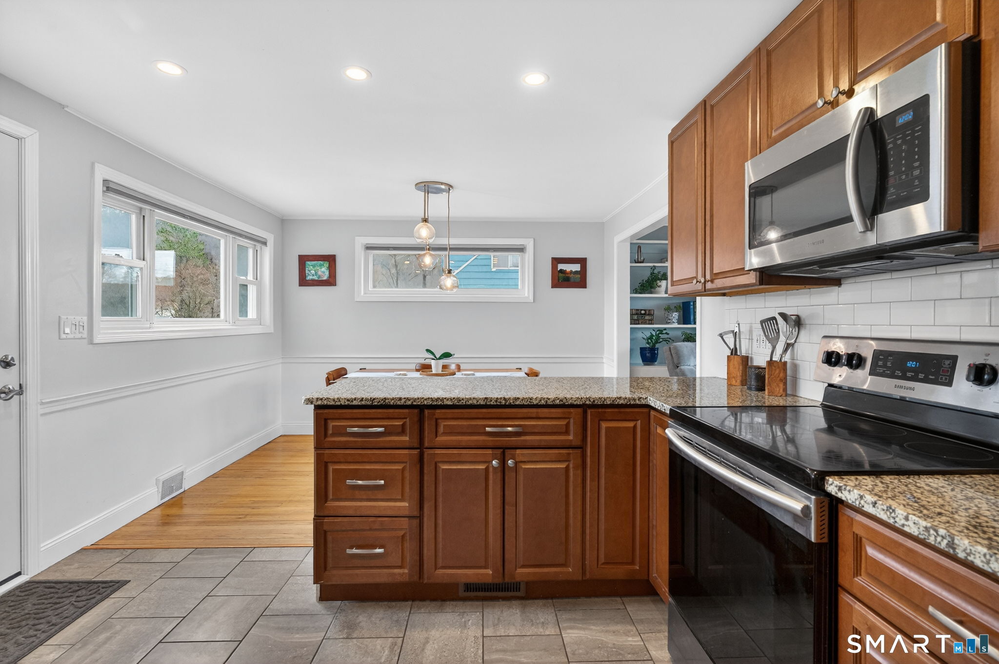 12 Lewis Street Simsbury, CT 06081 - Photo 11 of 35 a kitchen with stainless steel appliances granite countertop a sink and stove top oven