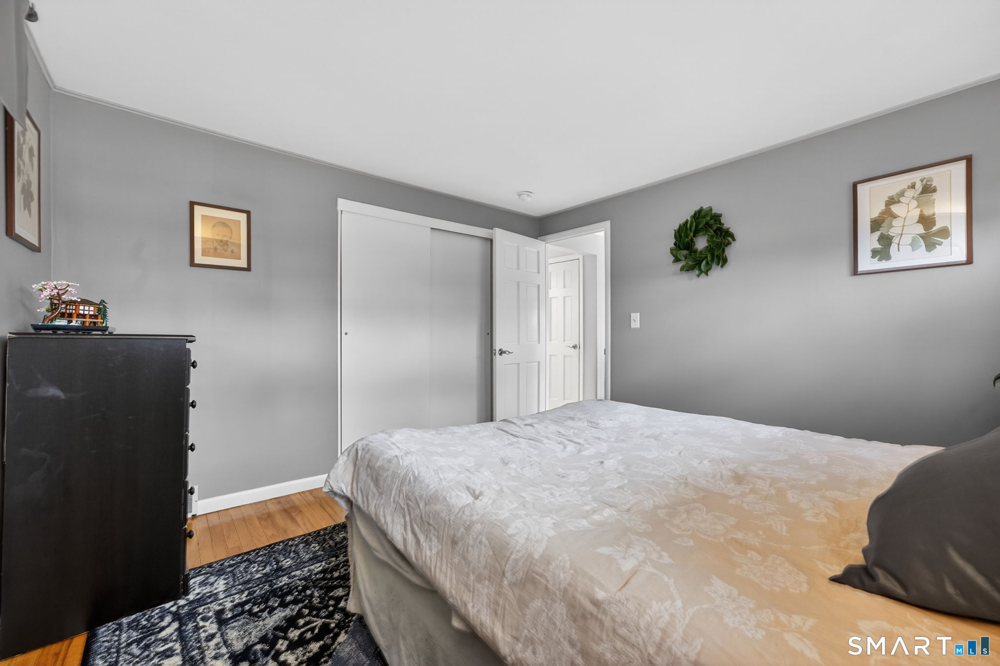 12 Lewis Street Simsbury, CT 06081 - Photo 12 of 35 a bedroom with a bed and painting on the wall