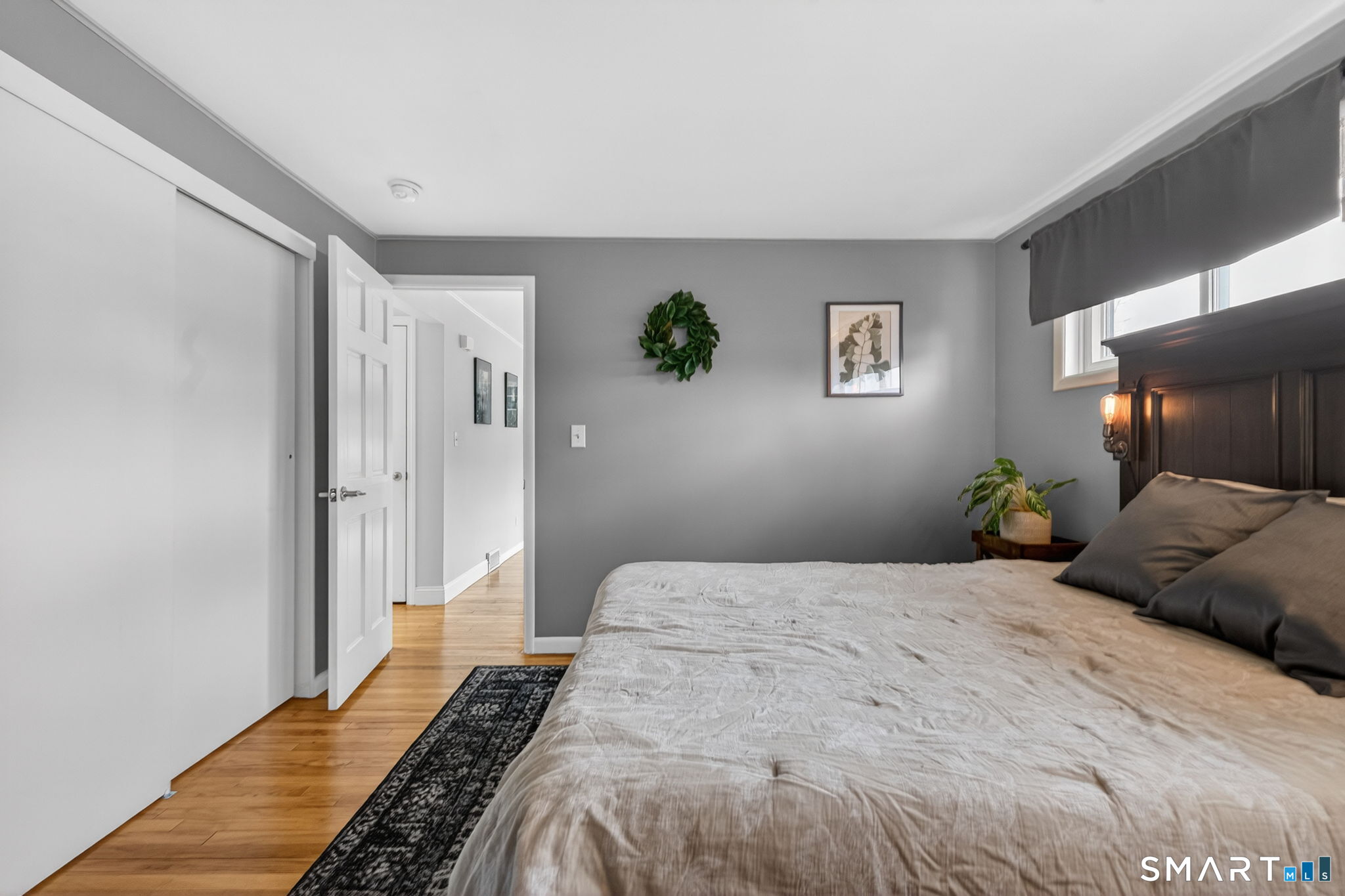 12 Lewis Street Simsbury, CT 06081 - Photo 13 of 35 a bedroom with a bed and a potted plant