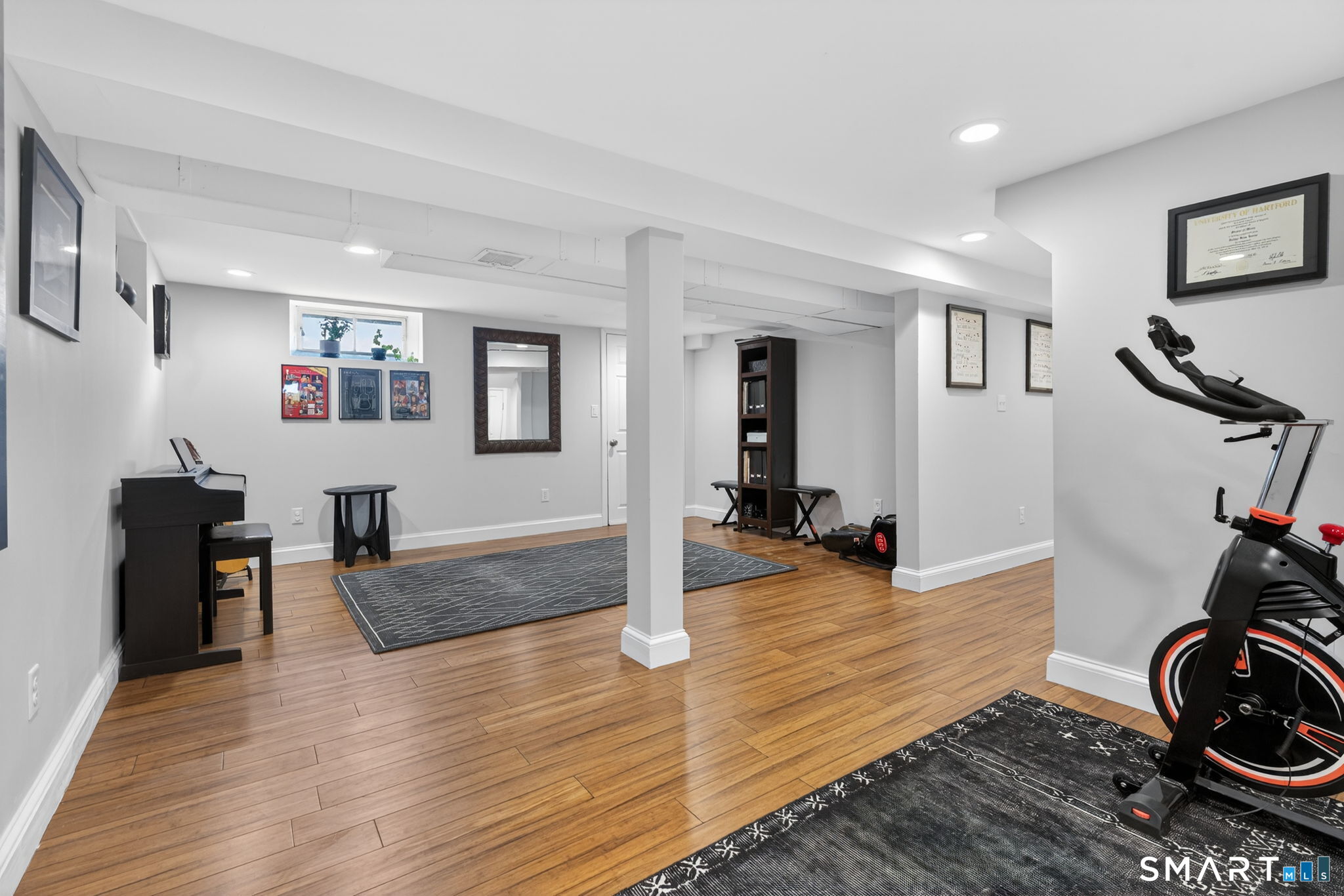 12 Lewis Street Simsbury, CT 06081 - Photo 22 of 35 a view of a livingroom with furniture and a flat screen tv