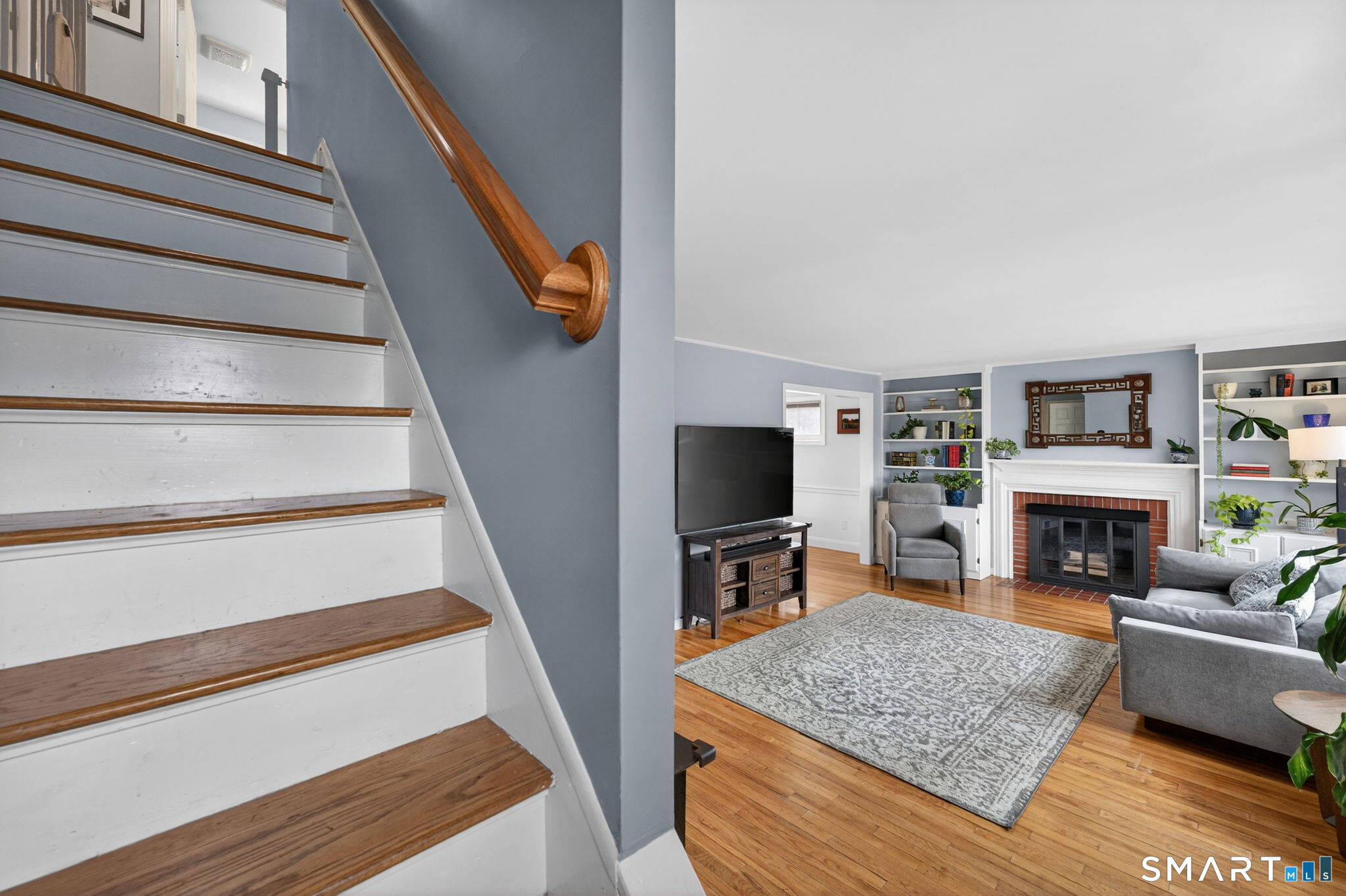 12 Lewis Street Simsbury, CT 06081 - Photo 25 of 35 a living room with furniture and a fireplace