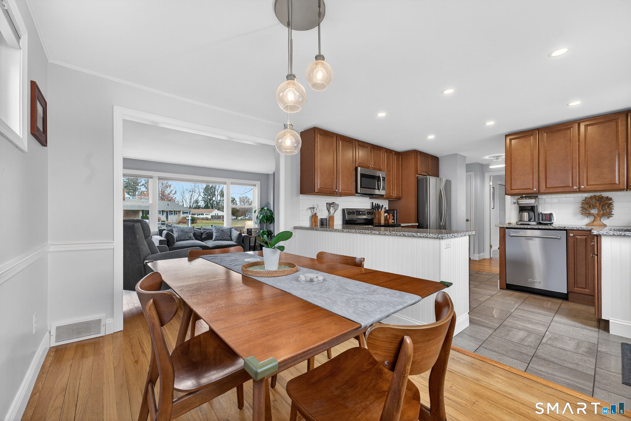 12 Lewis Street Simsbury, CT 06081 - Photo 8 of 35 a kitchen with a dining table chairs stainless steel appliances and cabinets