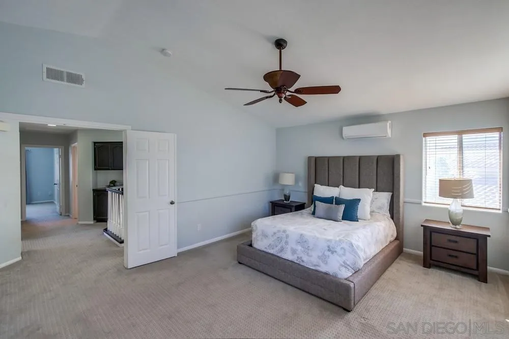 13748 Wyeth Road El Cajon, CA 92021 - Photo 17 of 36 a bedroom with a bed and a chandelier