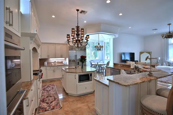 a kitchen with stainless steel appliances a sink stove and refrigerator