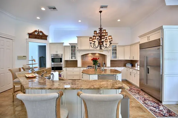 a large kitchen with a table and chairs