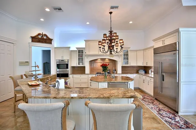 a large kitchen with a table and chairs