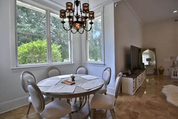 a view of a dining room with furniture window and outside view