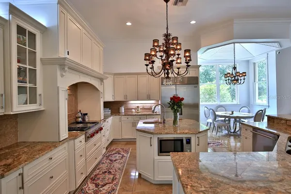 a large kitchen with a table and chairs