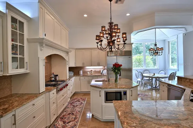 a large kitchen with a table and chairs