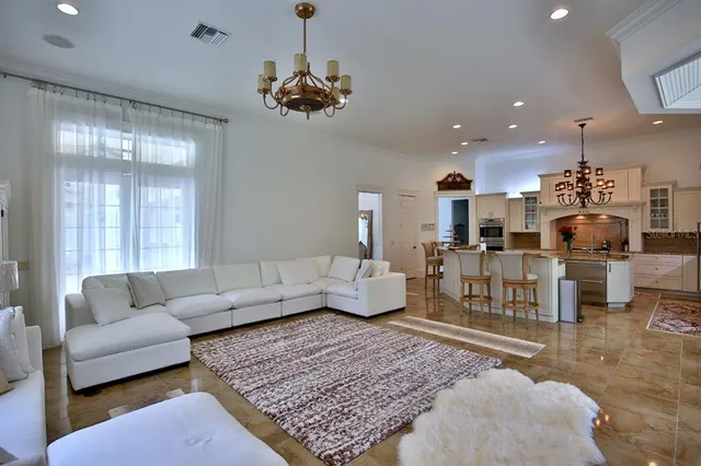 a living room with furniture and a chandelier
