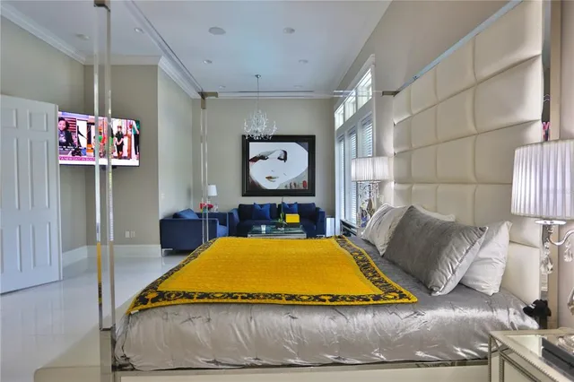 a spacious bedroom with a bed and glass window