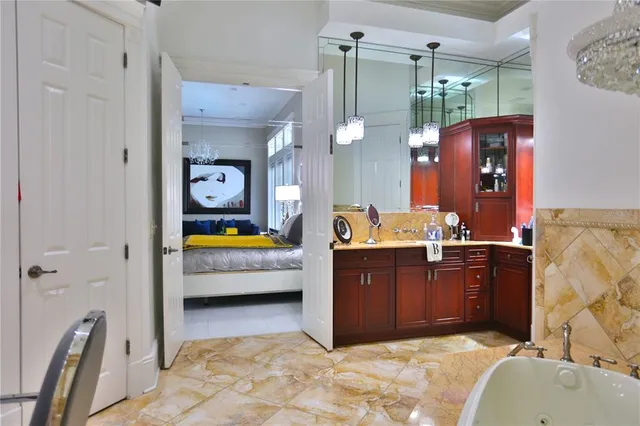 a bathroom with a tub sink and mirror