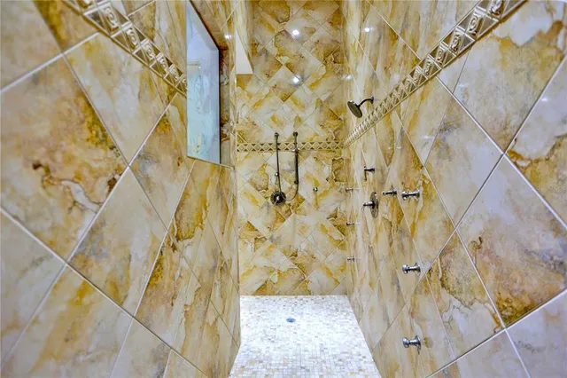 a bathroom with a tub sink and mirror