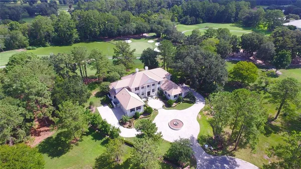 a aerial view of a house with a yard and garden