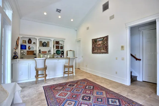 a view of a yard with plants and large trees
