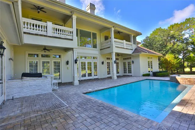 a living room with a couch and a ceiling fan
