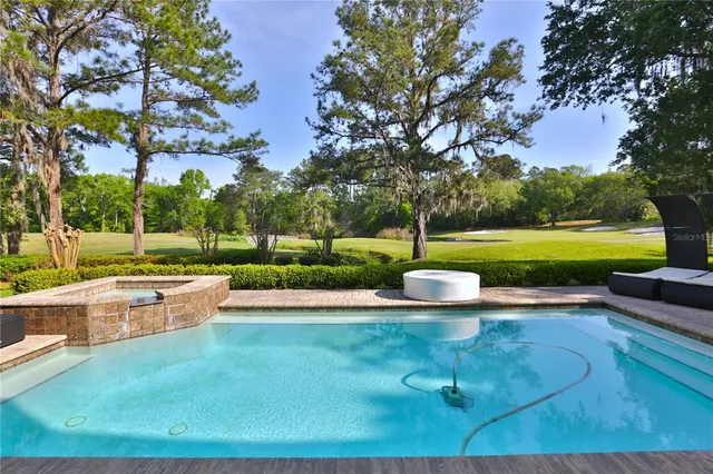 a view of swimming pool with outdoor seating and outdoor seating