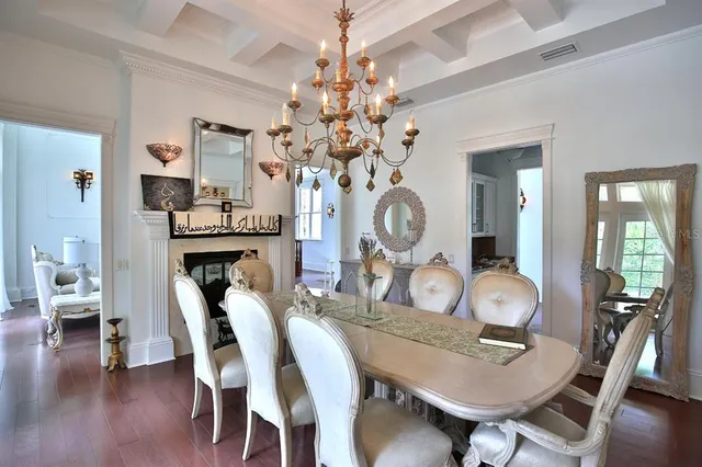 a view of a dining room with furniture wooden floor and chandelier