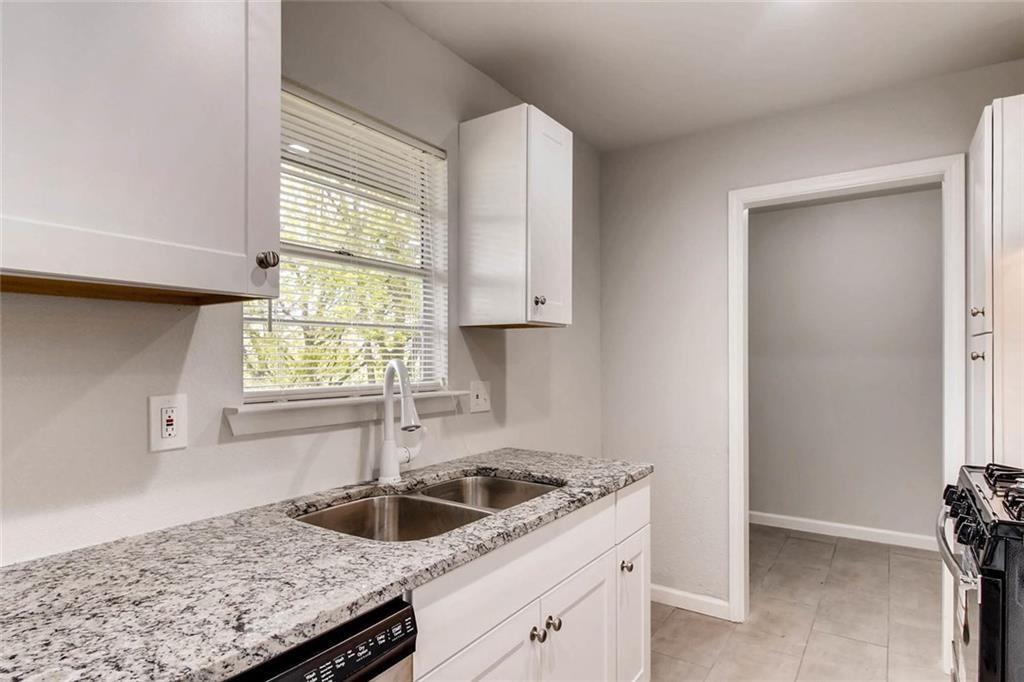 4903 Church Street Greenville, TX 75401 - Photo 2 of 10 a kitchen with granite countertop a sink and a window