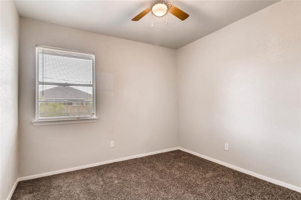 4903 Church Street Greenville, TX 75401 - Photo 5 of 10 an empty room with a window