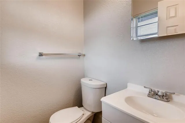 a white toilet sitting next to a bathroom sink