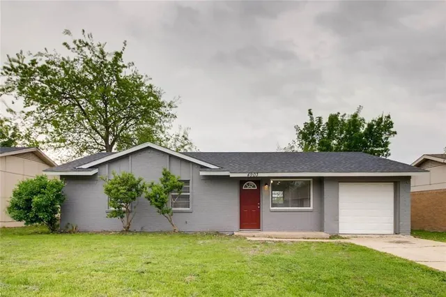 a front view of house with yard and trees