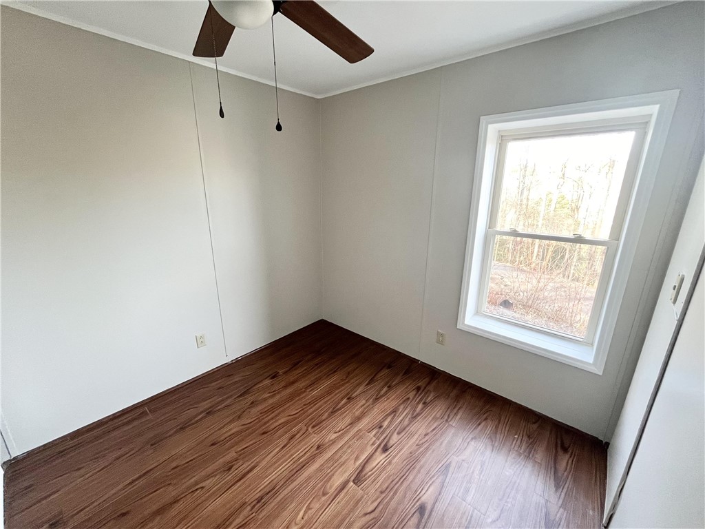 212 Whitewater Lake Road Tamassee, SC 29686 - Photo 6 of 9 Hardwood-style flooring and a window provide a sense of openness and nature.