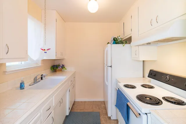 a kitchen with a sink a stove and refrigerator